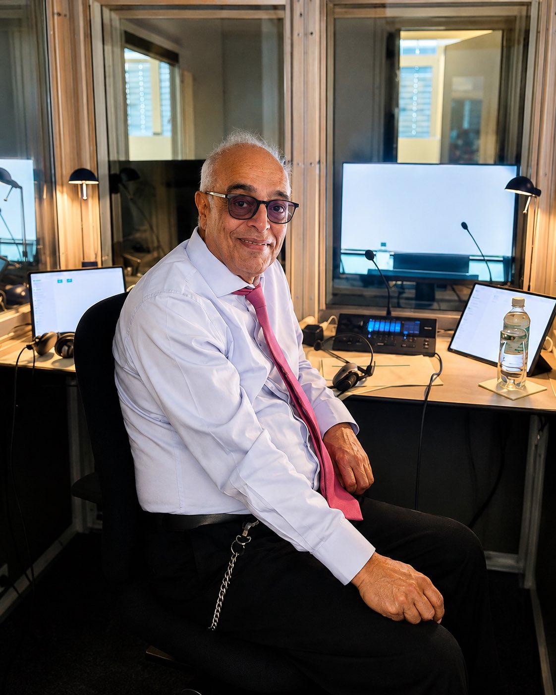 Rohit Nayar in an interpreting booth during a simultaneous interpreting assignment at VW